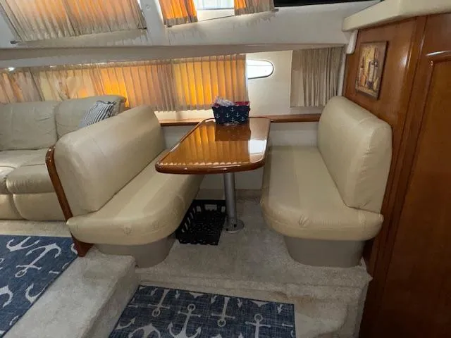 Slide: The Image of Interior of 2006 Carver 36 Motor Yacht with dining area and plush seating. - 30