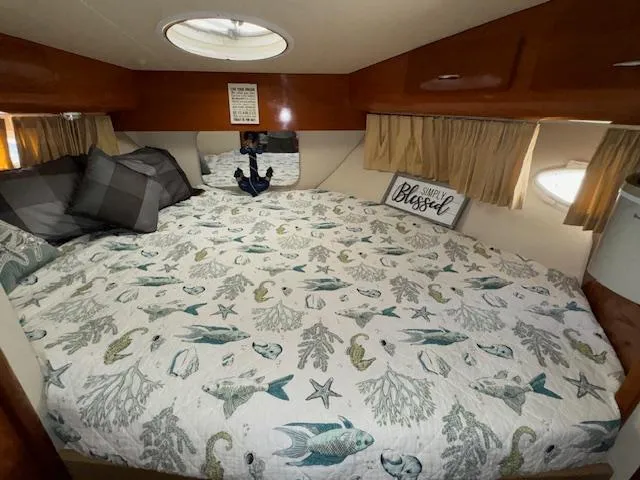 Slide: The Image of Cozy bedroom in 2006 Carver 36 Motor Yacht with nautical-themed bedding and decorative pillows. - 32
