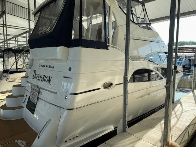 Slide: The Image of 2006 Carver 36 Motor Yacht docked in a marina, rear view. - 4