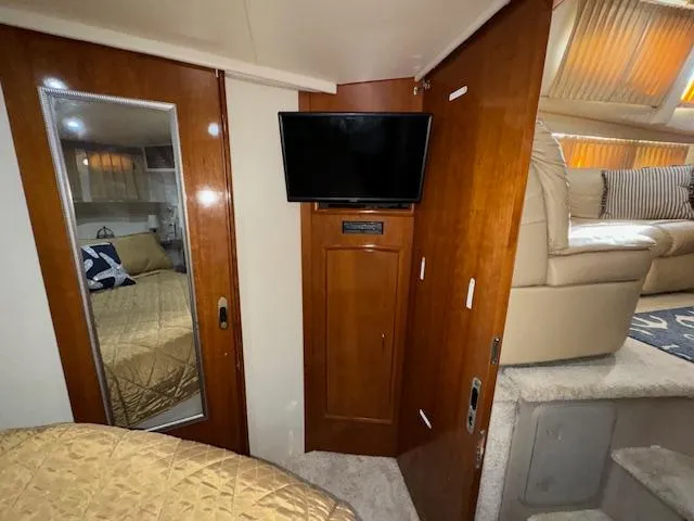 Slide: The Image of Interior of 2006 Carver 36 Motor Yacht with TV, mirror, and cozy seating area. - 40