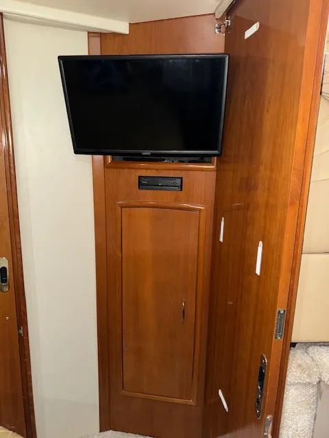 Slide: The Image of 2006 Carver 36 Motor Yacht interior with mounted TV and wooden cabinetry. - 41