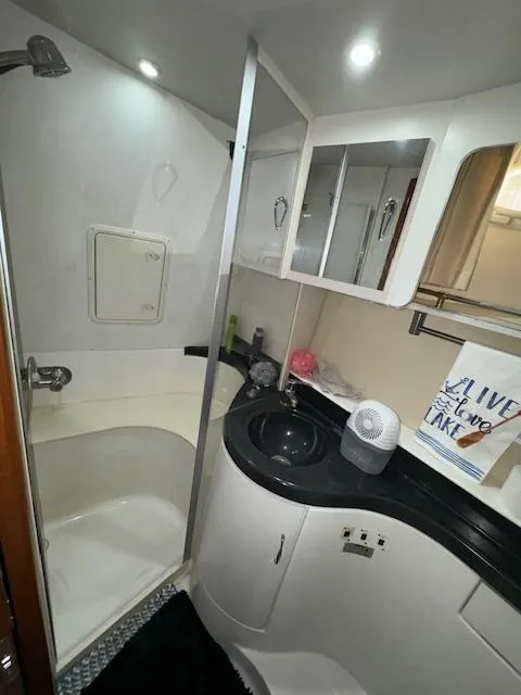 Slide: The Image of 2006 Carver 36 Motor Yacht bathroom with shower, sink, and storage cabinets. - 45