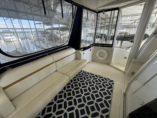 Slide: The Image of 2006 Carver 36 Motor Yacht interior with white seating and geometric rug. - 7