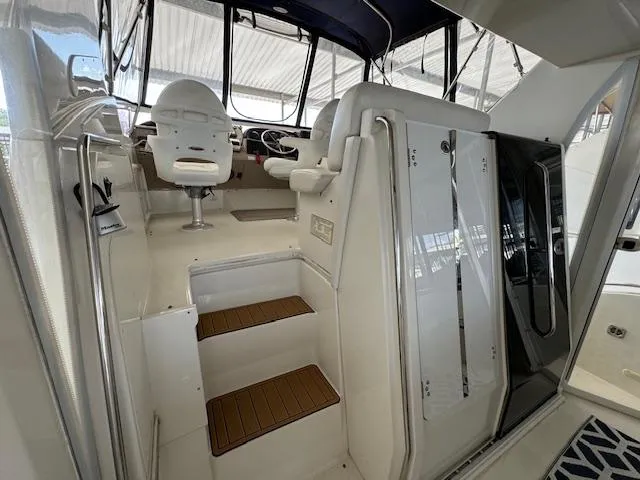 Slide: The Image of 2006 Carver 36 Motor Yacht interior with helm, seating, and steps. - 8