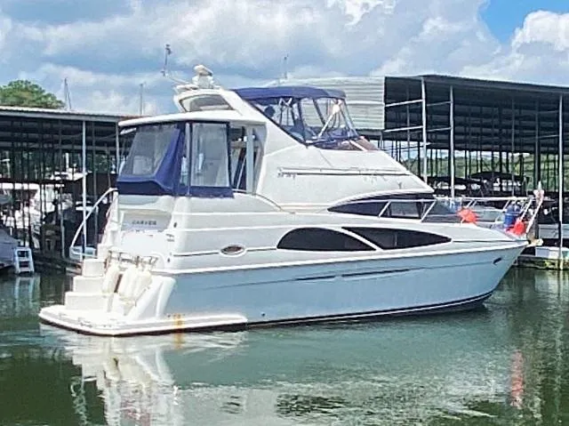 The Image of 2006 Carver 36 Motor Yacht docked in a marina under a partly cloudy sky. - 1