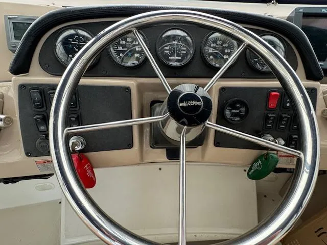 Slide: The Image of Steering wheel and dashboard of a 2006 Carver 36 Motor Yacht with gauges and controls. - 10