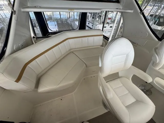 Slide: The Image of 2006 Carver 36 Motor Yacht interior with white seating and panoramic windows. - 20