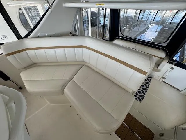 Slide: The Image of 2006 Carver 36 Motor Yacht interior with white leather seating and panoramic windows. - 21