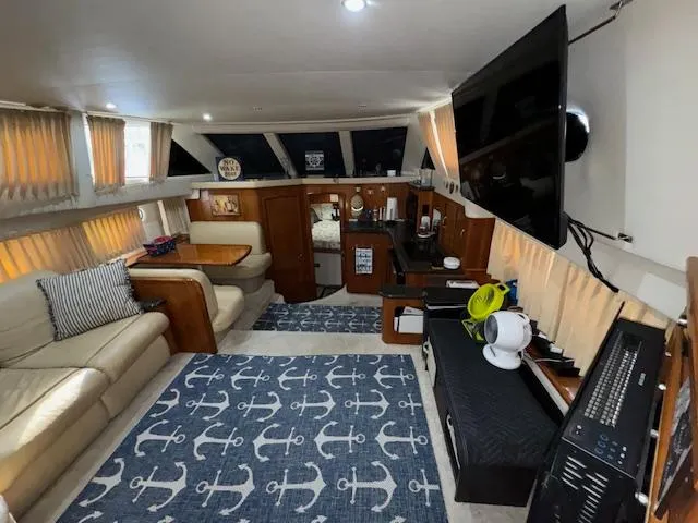 Slide: The Image of Interior of 2006 Carver 36 Motor Yacht with cozy seating and nautical decor. - 23