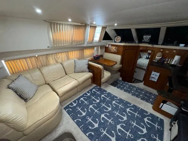 Slide: The Image of Interior of 2006 Carver 36 Motor Yacht with beige sofa and nautical-themed decor. - 24