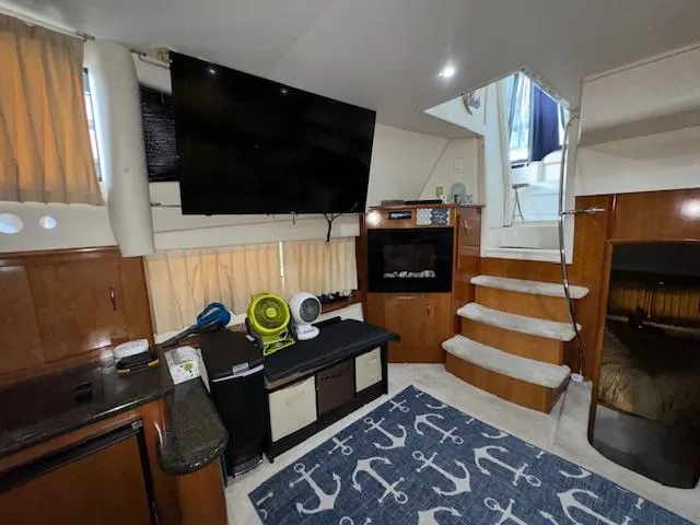 Slide: The Image of Interior of 2006 Carver 36 Motor Yacht with TV, stairs, and nautical-themed decor. - 26