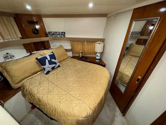 Slide: The Image of 2006 Carver 36 Motor Yacht bedroom with cozy bed, nautical decor, and mirrored closet. - 36