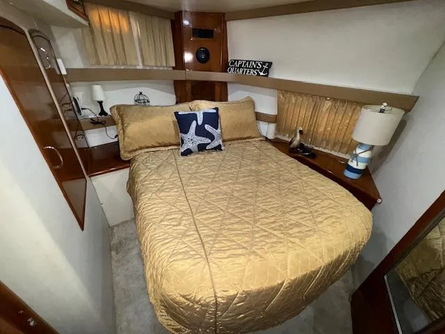 Slide: The Image of 2006 Carver 36 Motor Yacht bedroom with cozy bed and nautical decor. - 37