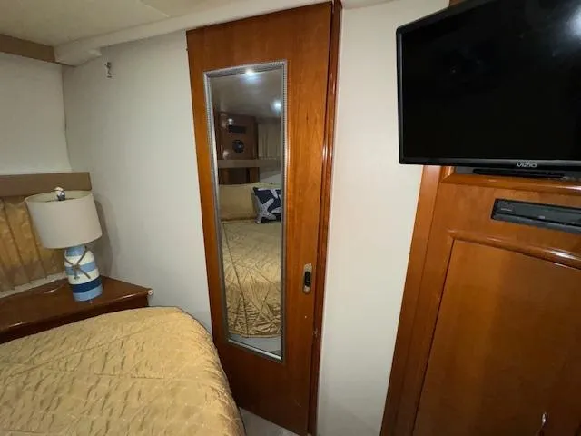 Slide: The Image of Interior of 2006 Carver 36 Motor Yacht with mirror, TV, and bed. - 42