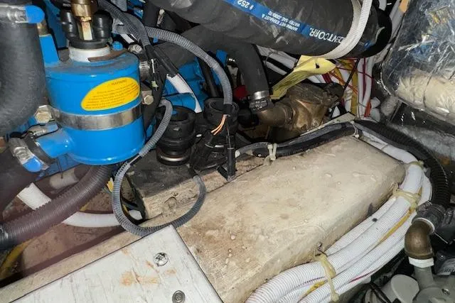 Slide: The Image of Engine room of 2006 Carver 36 Motor Yacht with visible hoses and components. - 57