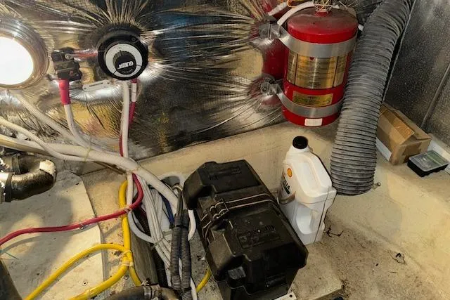 Slide: The Image of Engine room of 2006 Carver 36 Motor Yacht with wiring, fire extinguisher, and equipment. - 60