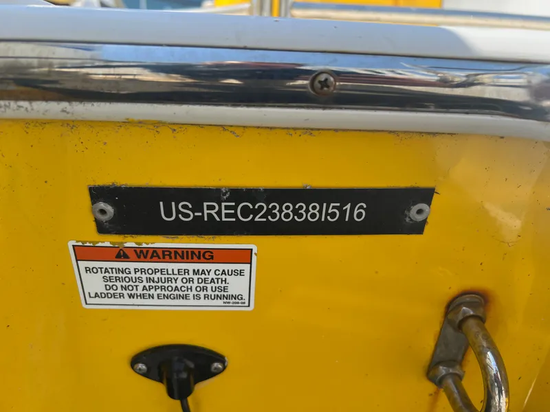 Slide: The Image of 2016 Caravelle RAZOR 238PR boat with warning label and registration number. - 12