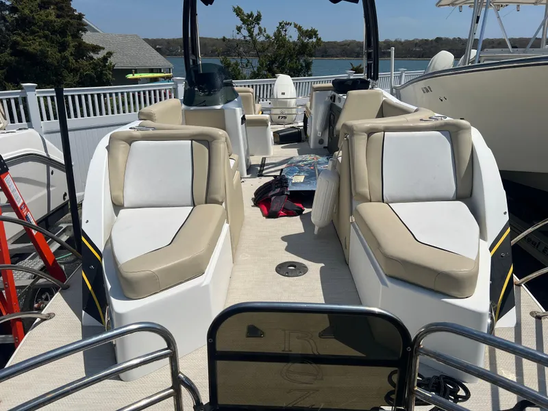 Slide: The Image of 2016 Caravelle RAZOR 238PR boat interior with beige seating and open deck layout. - 2