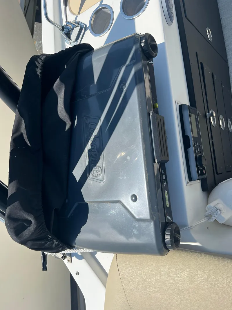 Slide: The Image of 2016 Caravelle RAZOR 238PR boat interior with storage compartment and control panel. - 3