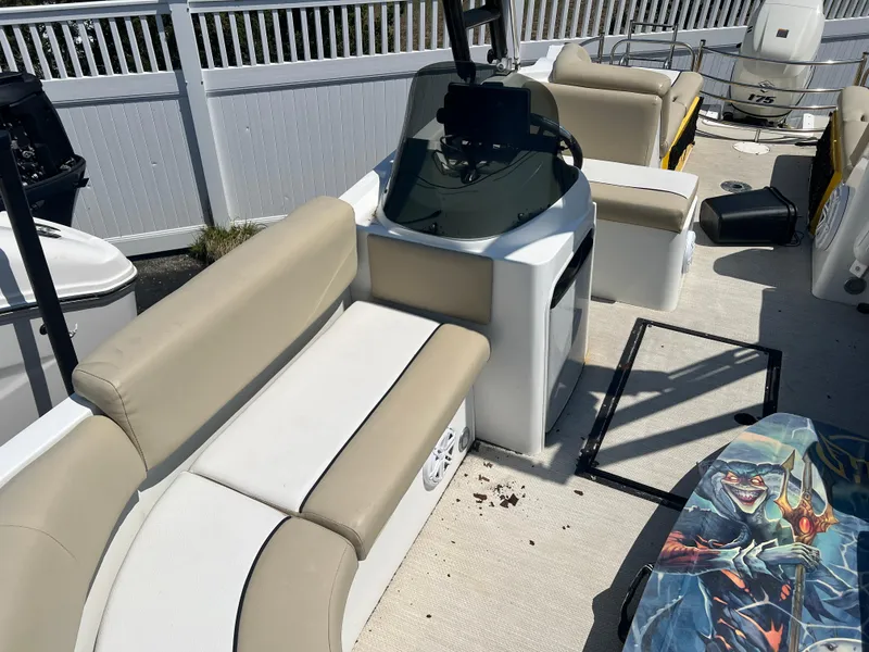 Slide: The Image of 2016 Caravelle RAZOR 238PR boat interior with beige seating and control console. - 4