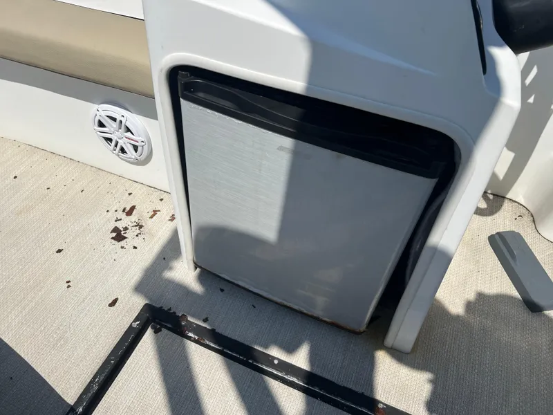 Slide: The Image of 2016 Caravelle RAZOR 238PR boat interior with a built-in mini fridge. - 8