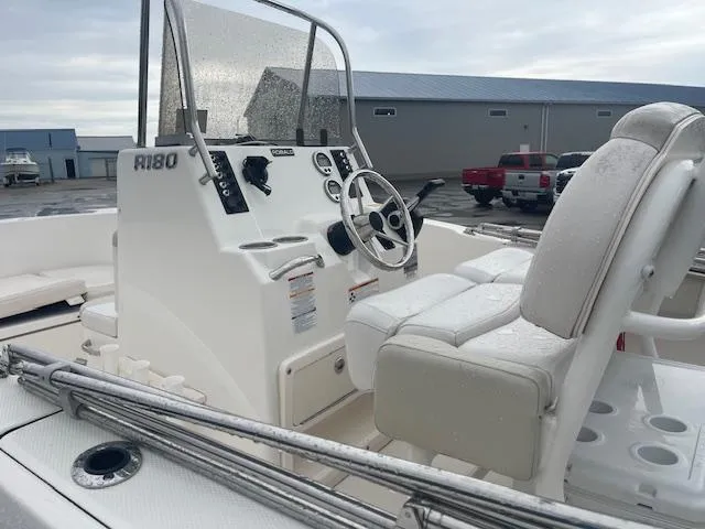 Slide: The Image of 2016 Robalo R180 CC boat interior with steering console and seating. - 7