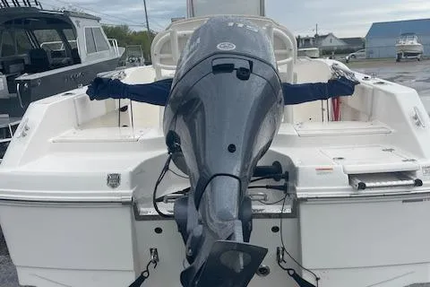 Slide: The Image of 2016 Robalo R180 CC boat with outboard motor, docked in a marina. - 9