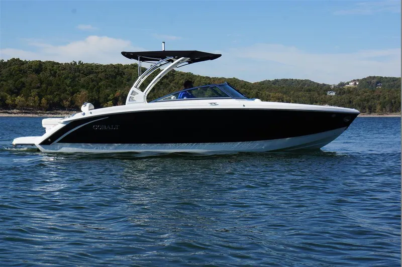 Slide: The Image of 2017 Cobalt R7 boat cruising on a lake with scenic forested background. - 1