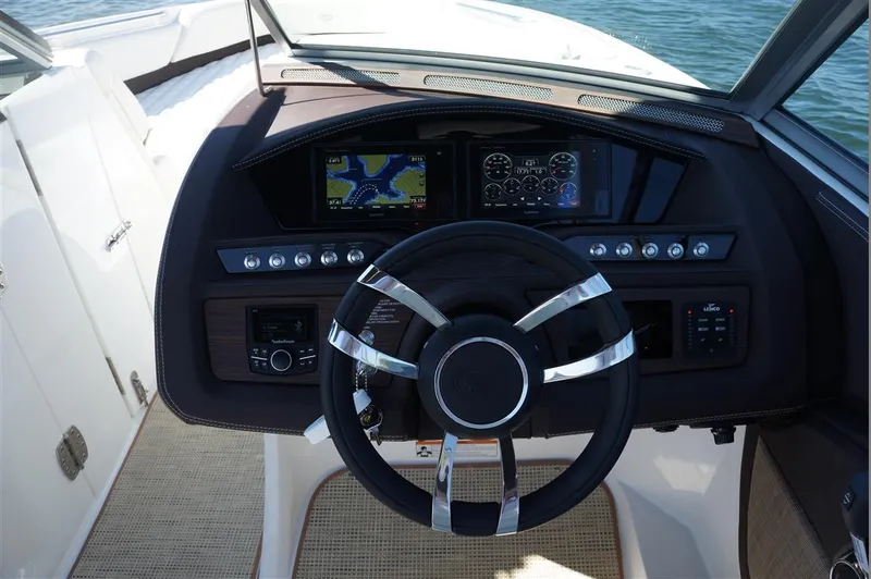 Slide: The Image of Steering wheel and dashboard of 2017 Cobalt R7 boat, featuring navigation and control panels. - 12