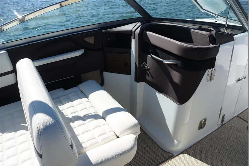 Slide: The Image of 2017 Cobalt R7 boat interior with white seating and sleek design on open water. - 14
