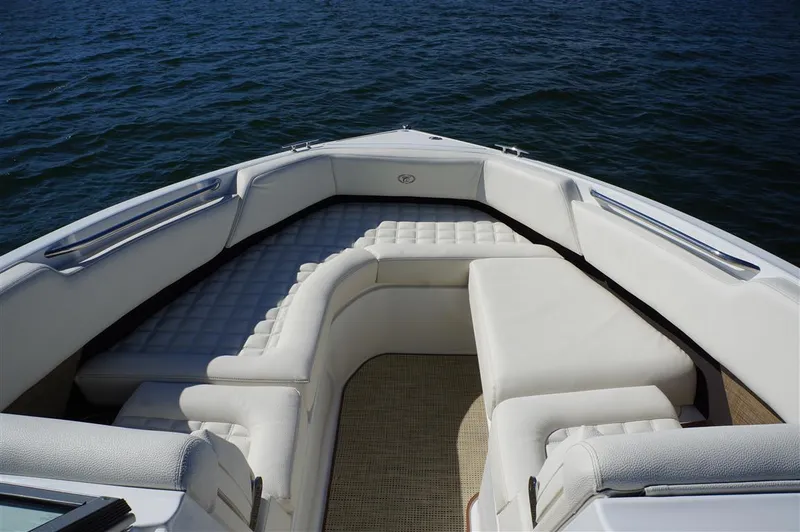 Slide: The Image of 2017 Cobalt R7 boat interior with white cushioned seating on calm water. - 17