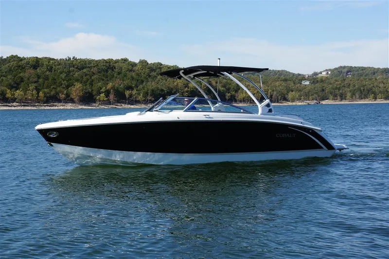 Slide: The Image of 2017 Cobalt R7 boat cruising on a lake with scenic forested background. - 3