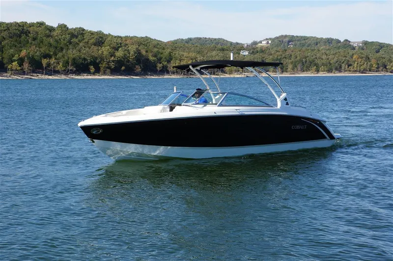 Slide: The Image of 2017 Cobalt R7 boat cruising on a serene lake with forested shoreline. - 4