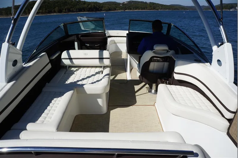 Slide: The Image of 2017 Cobalt R7 boat interior with white seating, on a lake. - 8