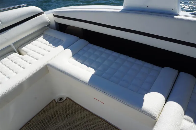 Slide: The Image of 2017 Cobalt R7 boat interior with white cushioned seating and water view. - 9