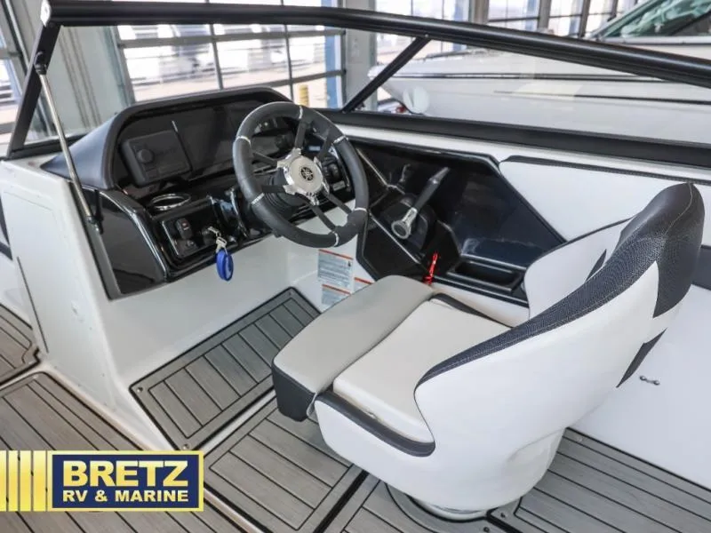 Slide: The Image of 2024 Model 195 S boat interior with steering wheel and captain's seat at Bretz RV & Marine. - 10
