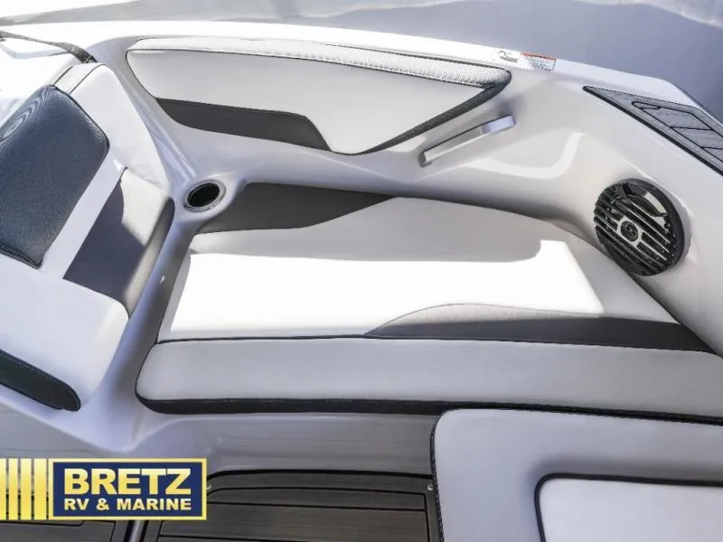 Slide: The Image of 2024 Model 195 S boat interior with sleek seating and speaker, Bretz RV & Marine branding. - 14