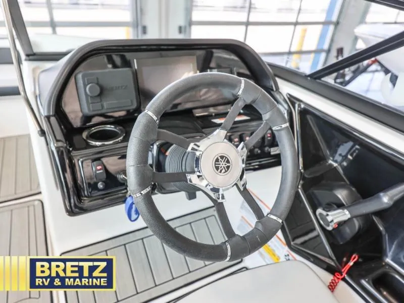 Slide: The Image of Steering wheel of a 2024 model 195 S boat at Bretz RV & Marine showroom. - 18