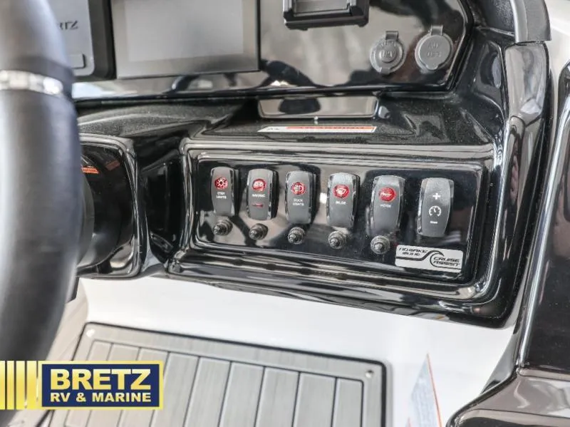 Slide: The Image of Dashboard controls of a 2024 model 195 S boat, featuring various switches and buttons. - 19