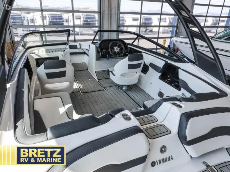 Slide: The Image of 2024 Yamaha 195 S boat interior with sleek seating and modern dashboard at Bretz RV & Marine. - 5