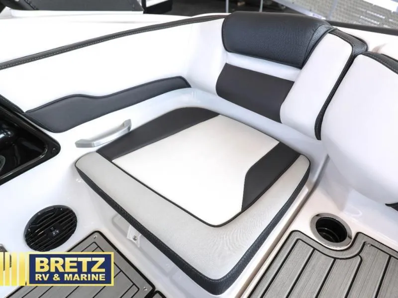 Slide: The Image of 2024 Model 195 S boat interior with cushioned seating, cup holder, and speaker. - 9