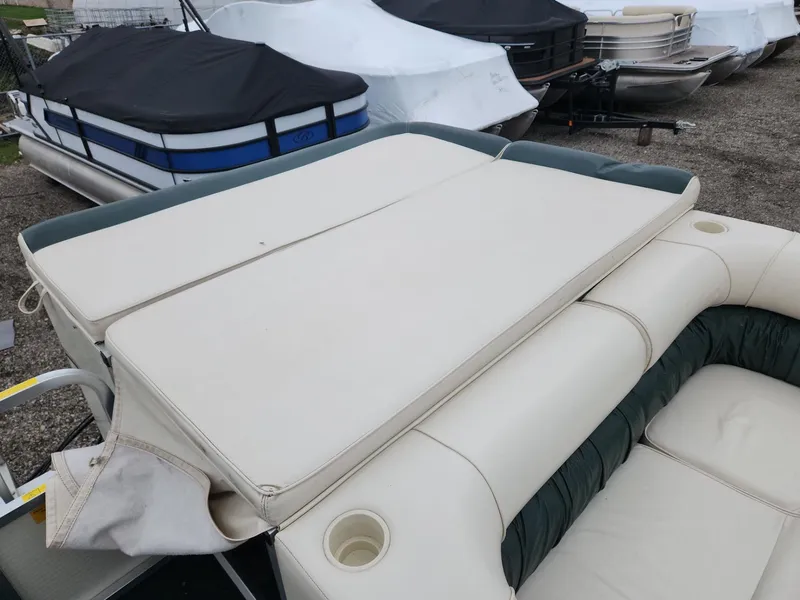 Slide: The Image of 2005 Tahoe Pontoon GRAND TAHOE XRP 23 with covered seating area, docked among other boats. - 17