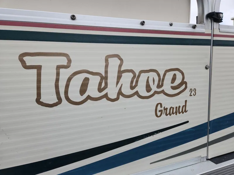 Slide: The Image of 2005 Tahoe Pontoon GRAND TAHOE XRP 23 logo on boat exterior. - 18