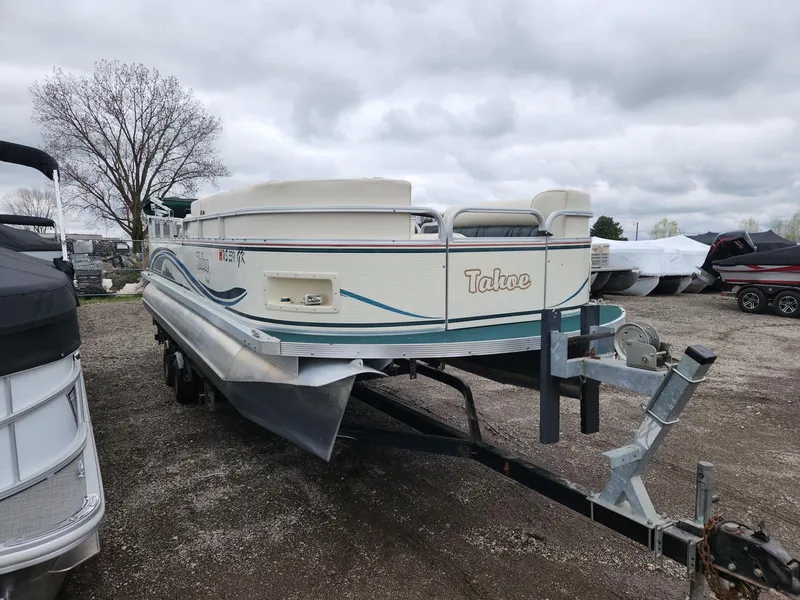 Slide: The Image of 2005 Tahoe Pontoon GRAND TAHOE XRP 23 on trailer, parked outdoors under cloudy sky. - 3