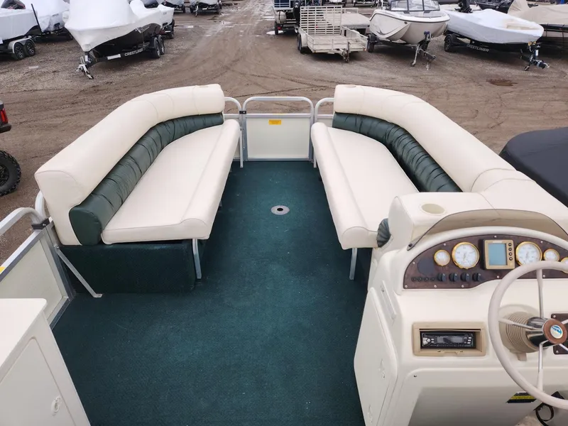 Slide: The Image of 2005 Tahoe Pontoon GRAND TAHOE XRP 23 interior with plush seating and control panel. - 8