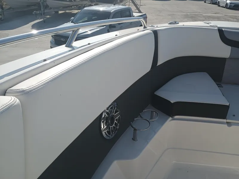 Slide: The Image of 2024 Chaparral 280 OSX boat interior with cushioned seating and cup holders. - 10