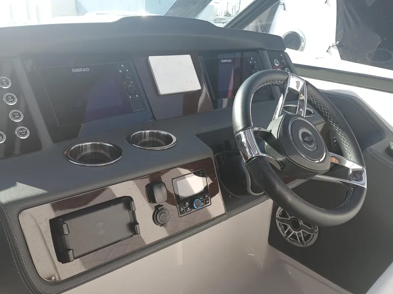 Slide: The Image of 2024 Chaparral 280 OSX helm with modern controls and steering wheel. - 12