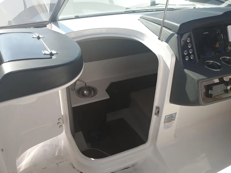 Slide: The Image of 2024 Chaparral 280 OSX boat interior with helm and cabin entrance. - 15
