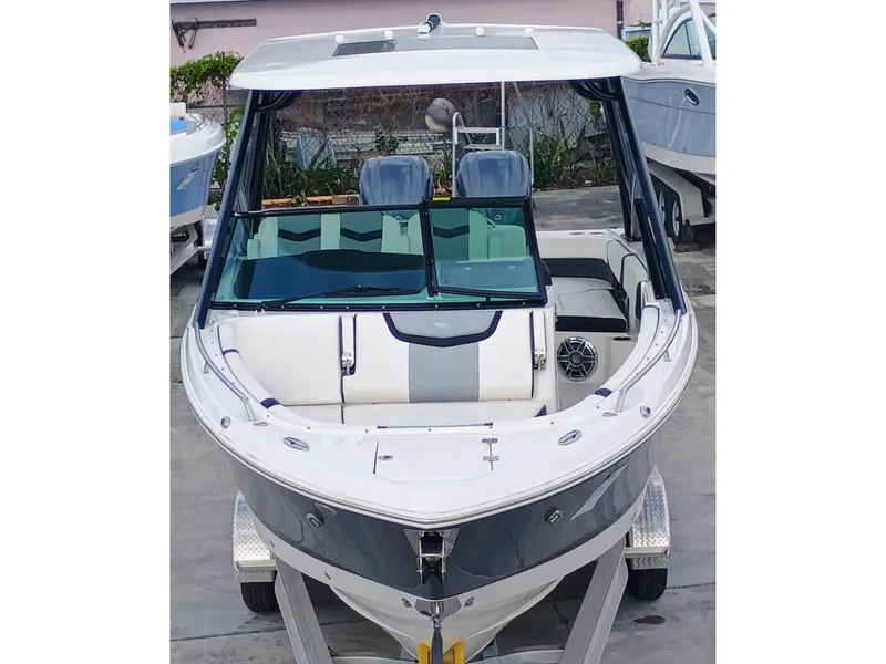 Slide: The Image of 2024 Chaparral 280 OSX boat, front view, on a trailer, sleek design, modern features. - 2