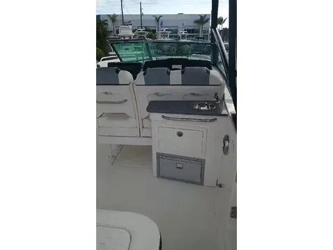 Slide: The Image of 2024 Chaparral 280 OSX boat interior with seating and kitchenette area. - 21